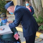 Cornerstone Hospice Chaplain Lt. Col. Mark Jurkowski honors a veteran a Superior Residences