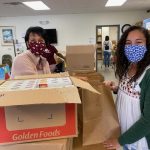 Volunteers pack food boxes at Faith Neighborhood Center