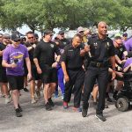 Torch Run Runners at Starting Line with Torch, held by Chief Broadway