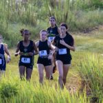 Freshman Taylor Walker and Junior Neely Lugo working past a group of opponents along the NTC course