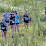 Junior Madi McCormack working past a group of opponents along the NTC course