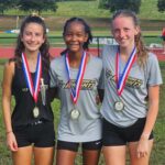 Rhyen Foley, Taylor Walker, and Hanna Warren with their medals after the varsity race