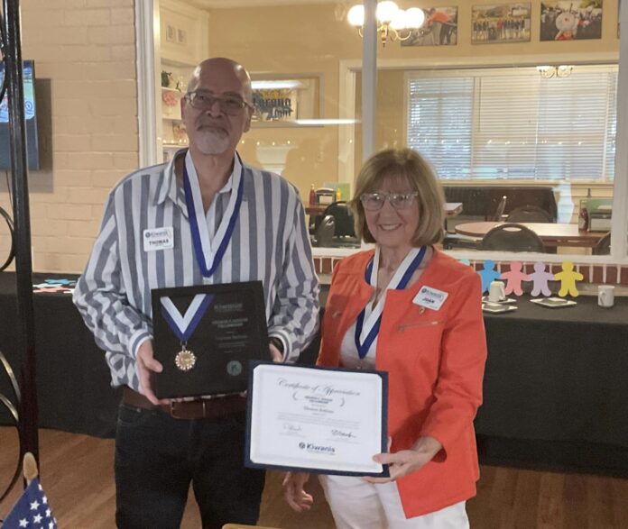 Kiwanis Club of Clermont -(L) Thom Battisto is honored with the Hixson Award (R) presented by Joan Kyle